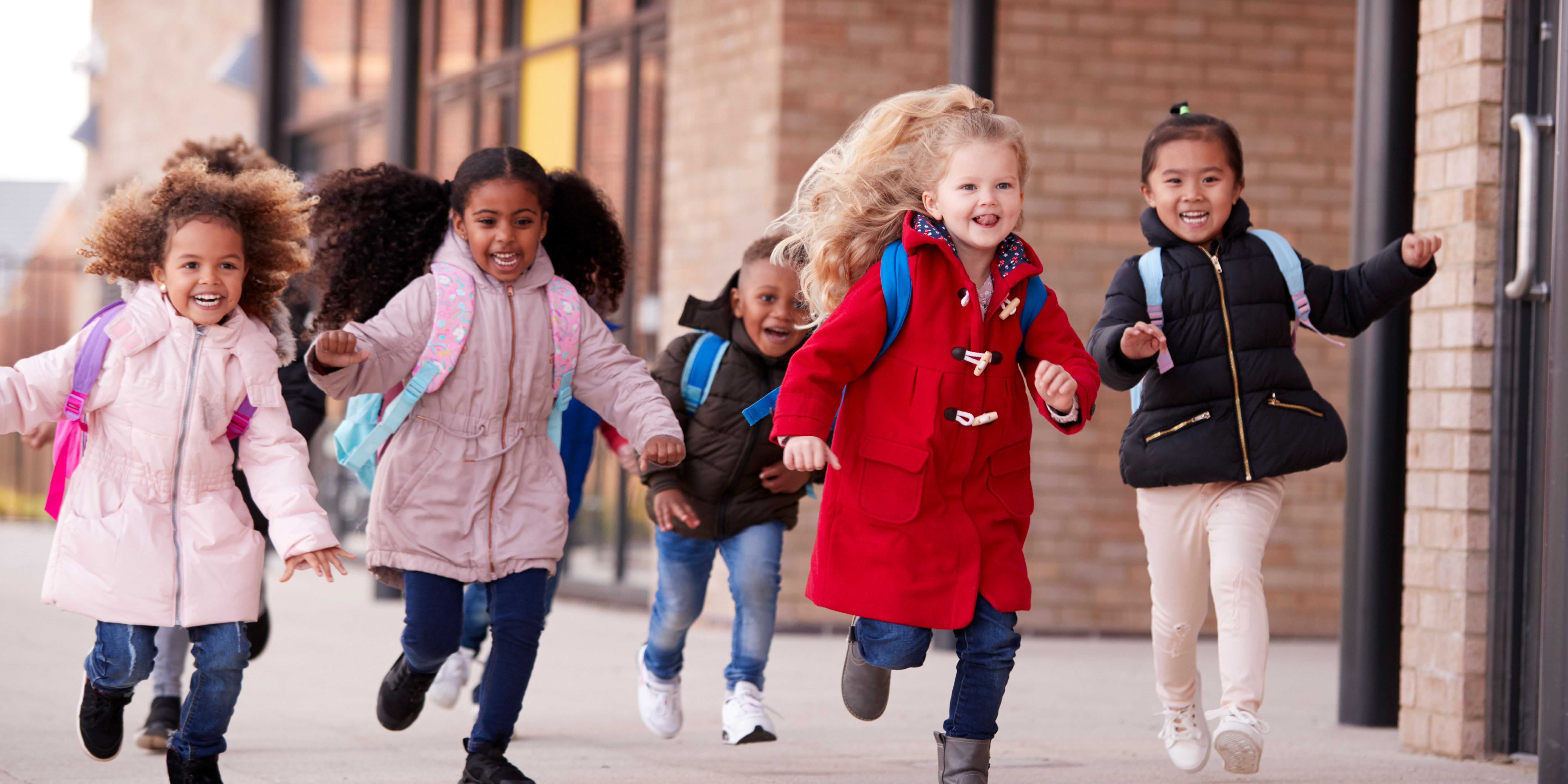 Little baby is sleeping in dad's arms while her sister is ki