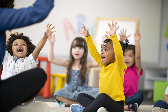 A multi-ethnic group of preschool students sitting on the fl