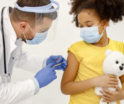 Child getting immunization shot from Doctor